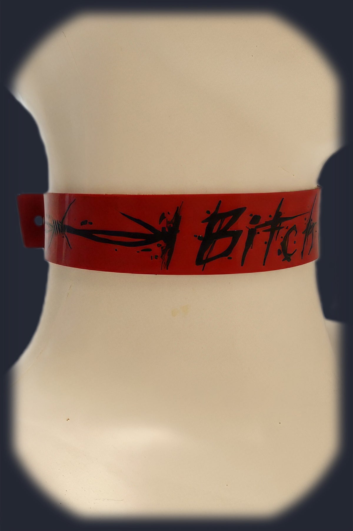 Red latex collar shown flat, custom painted lettering