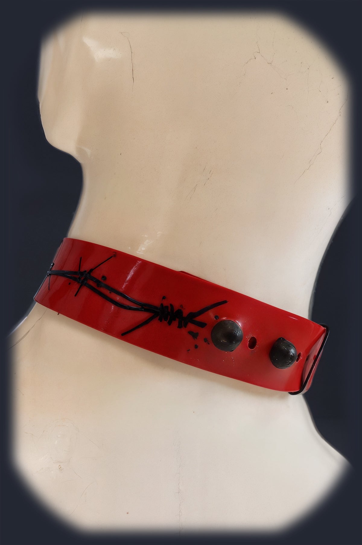 Red latex collar laid flat showing the stretchable band